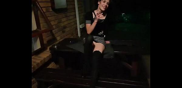 Petite brunette posing in different positions while smoking a cigarette outside in the garden